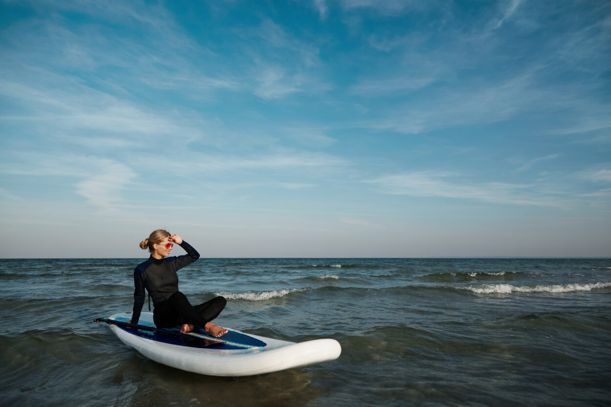 young blonde female paddleboard sea scaled